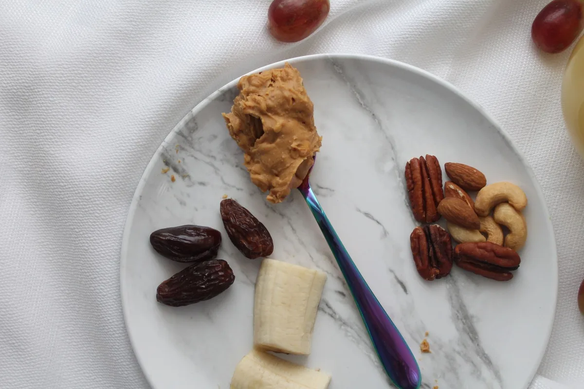 Ingredientes para o Snickers caseiro: tâmaras, manteiga de amendoim, chocolate derretido e amendoins picados