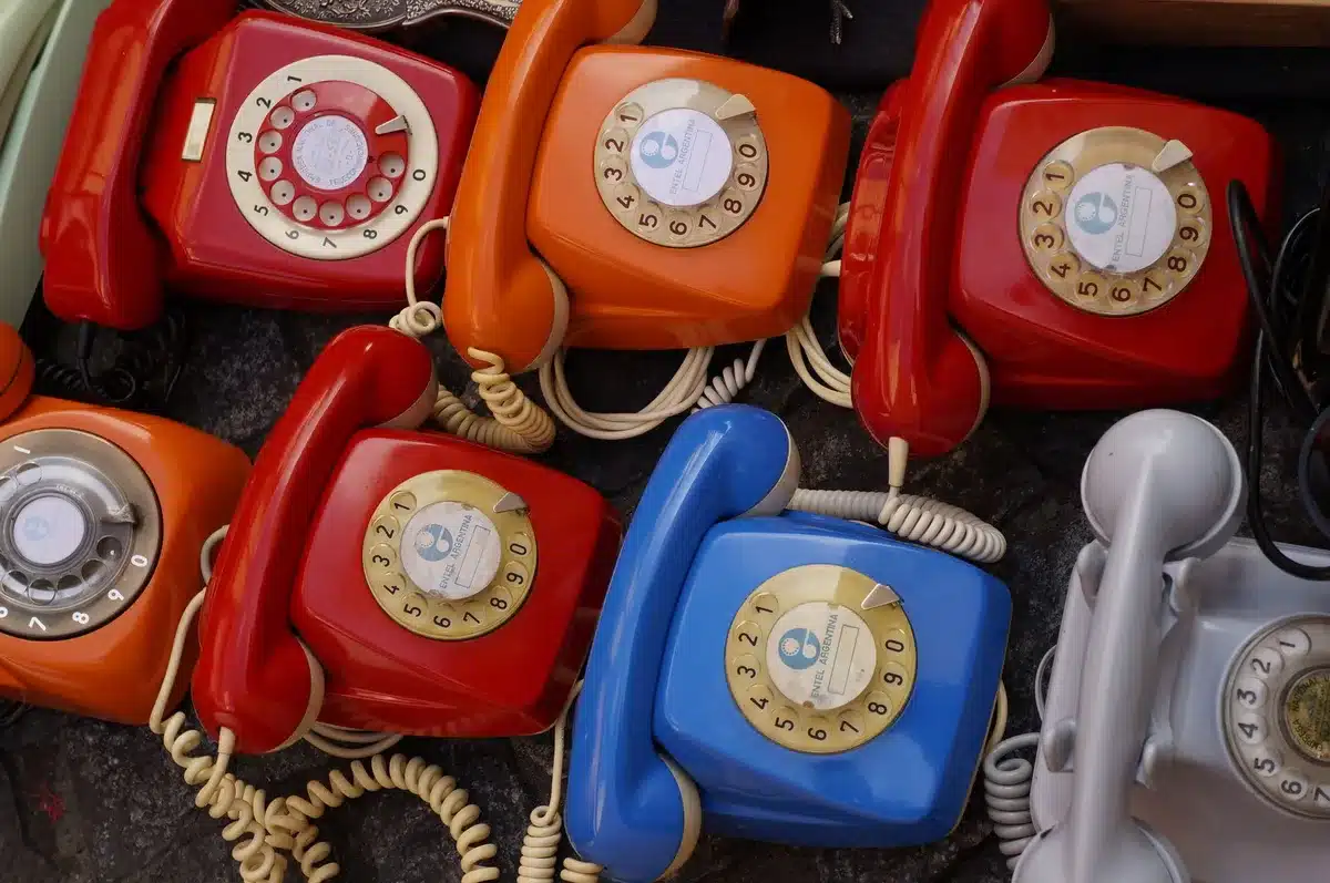 close-up of anonymous hands comparing two boxed phones on a table, blurred store background