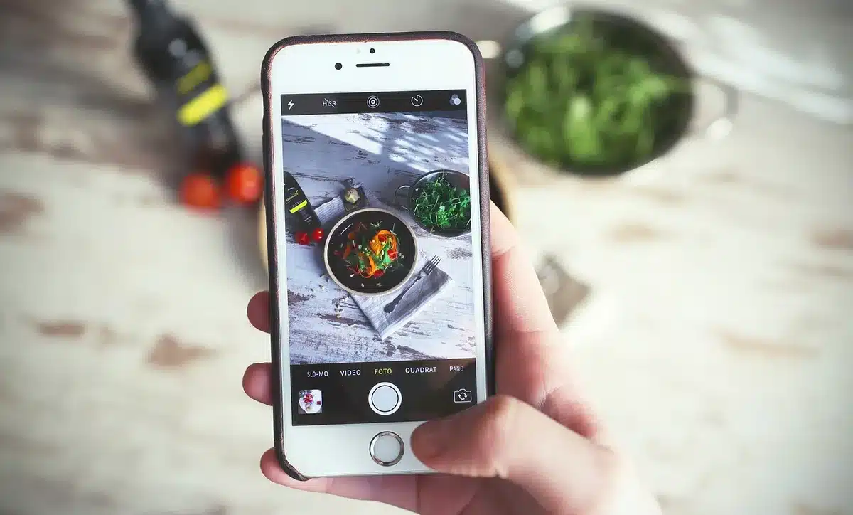 flatlay of anonymous phone next to a camera roll with generic icons suggesting image selection, no brands or text