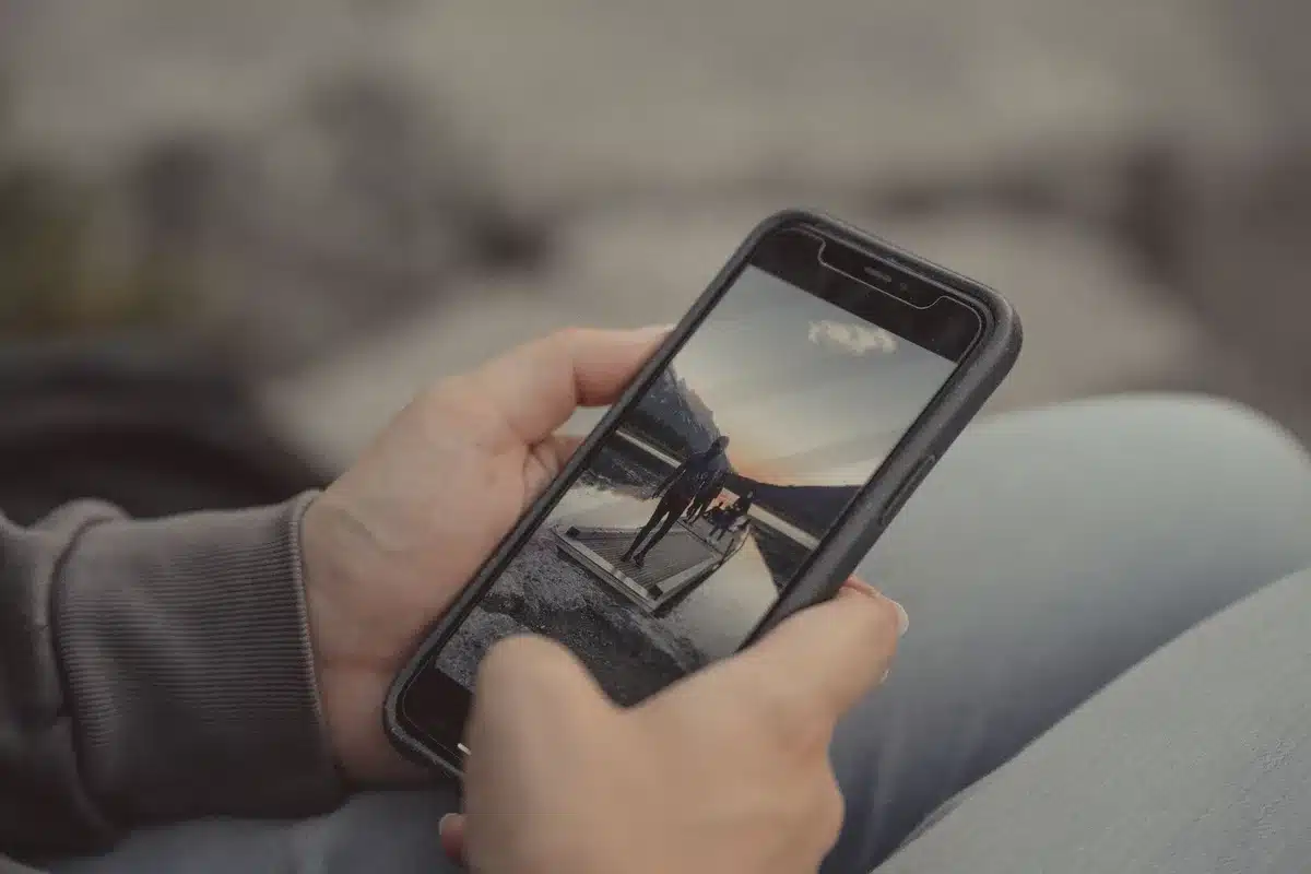 Rugged smartphone body with a removable battery compartment exposed, no logos or identifiable marks, on a workbench