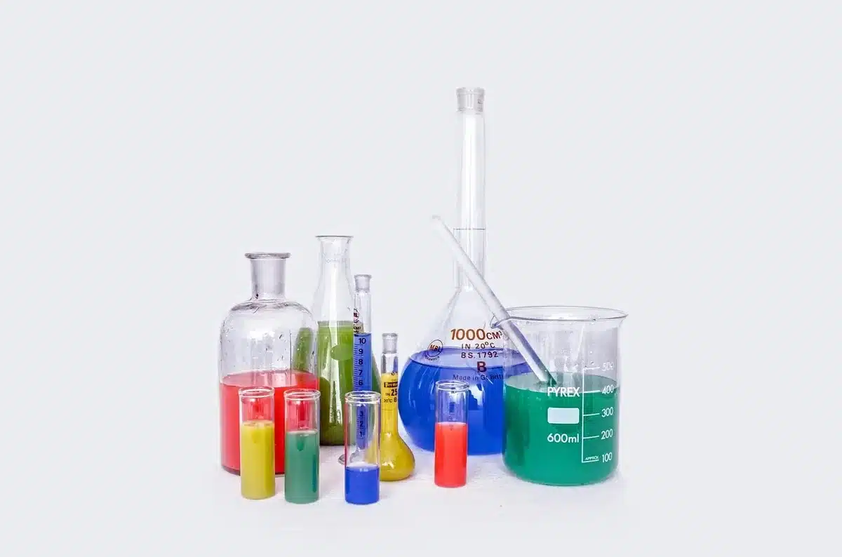 an empty laboratory bench with glass beakers and a clear water vial, no labels or logos, soft diffuse light