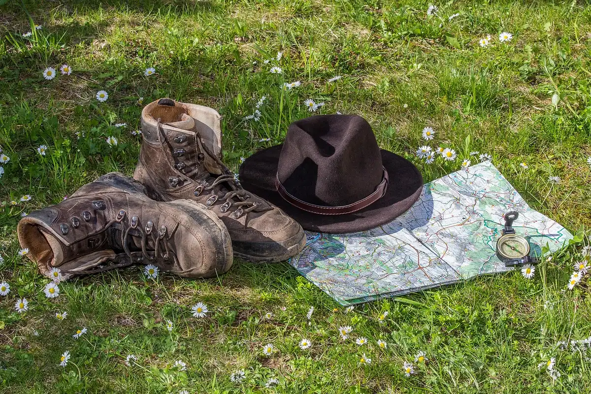 anonymous hiking boots on a shelf, two colours visible, no brand, soft indoor lighting