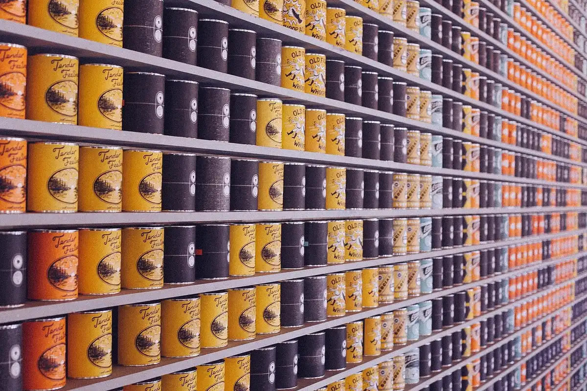 Close-up of a generic supermarket aisle showing a promotional shelf tag space and boxed footwear, anonymous environment, no brand names