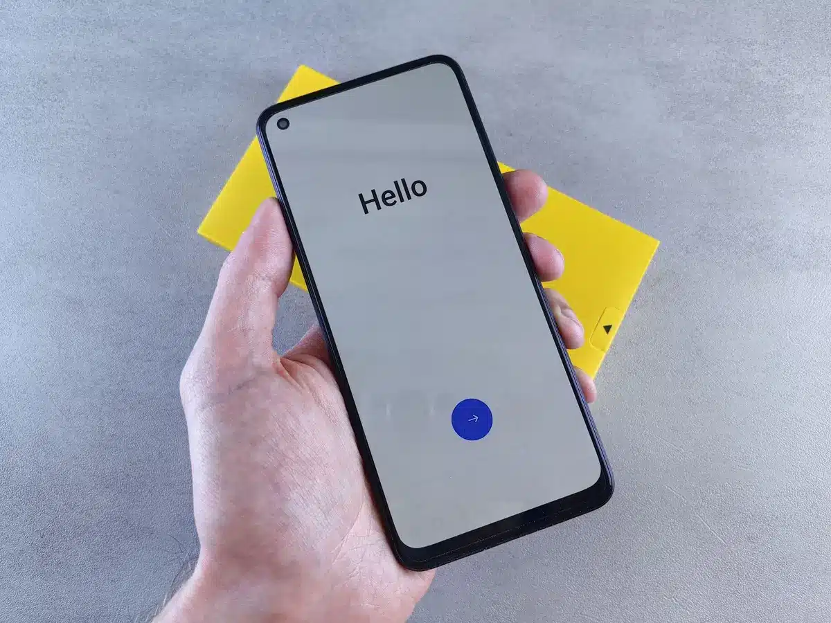 Empty retail shelf with boxed unbranded smartphones and a single bright display showing a blurred discount tag