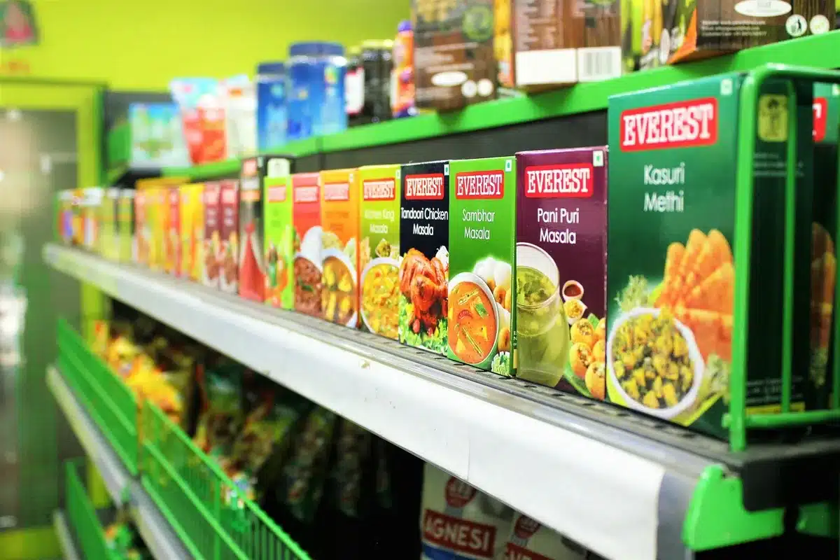 empty retail shelf with anonymous shoppers browsing, price tags visible but unreadable